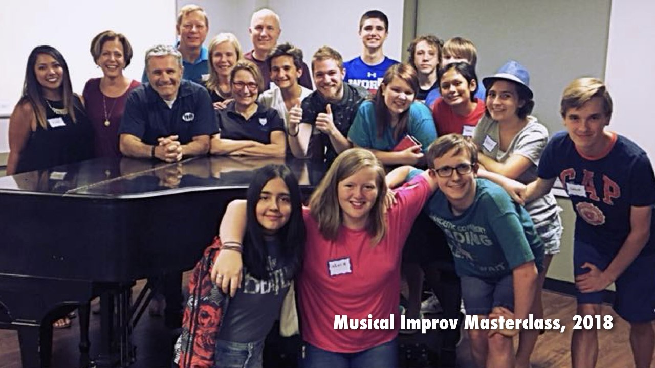 group of students and instructors gathered around piano